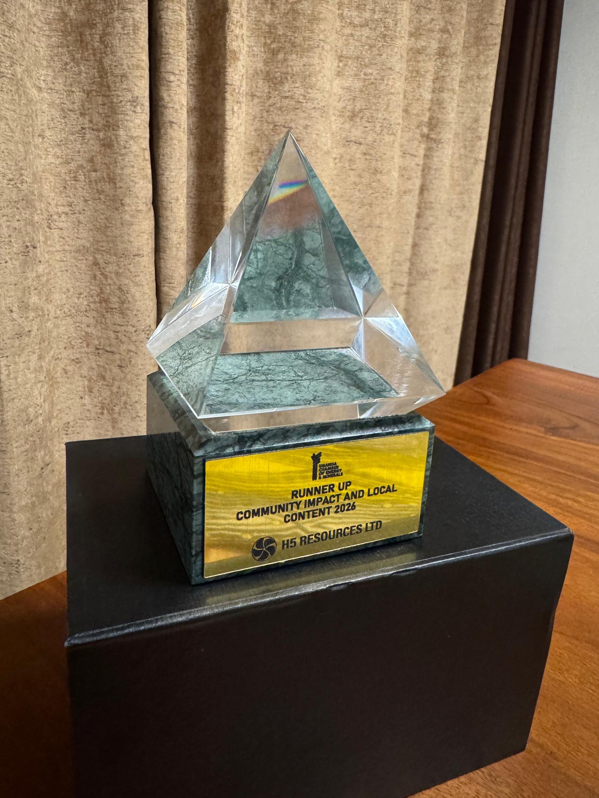 A crystal pyramid on a green marble base with a plate engraved Runner Up, Community Impact and Local Content 2026, H5 Resources Ltd.